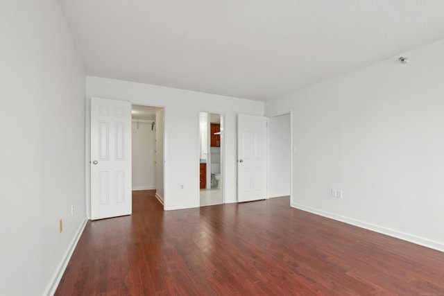 empty room with dark wood-type flooring