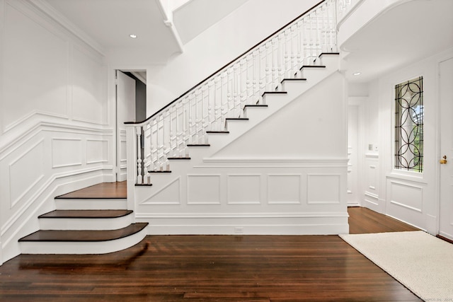 stairs featuring hardwood / wood-style floors