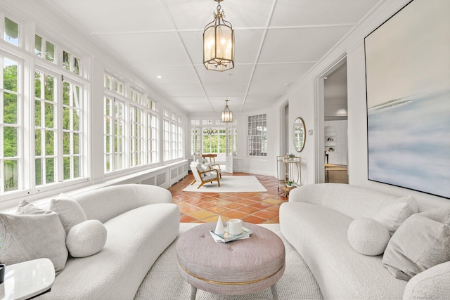 sunroom featuring an inviting chandelier