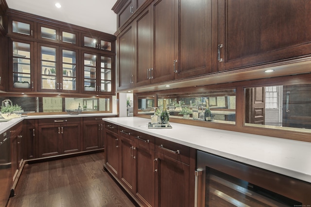 kitchen featuring dark brown cabinetry, dark wood-type flooring, beverage cooler, and black dishwasher