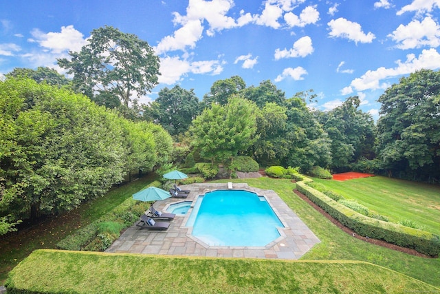 view of pool featuring a yard and a patio