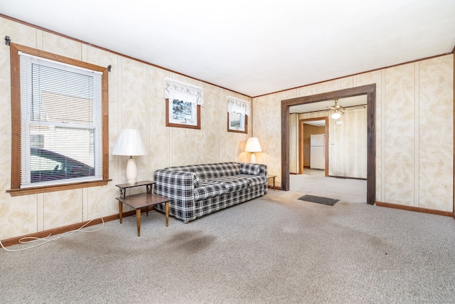 carpeted living room featuring ceiling fan