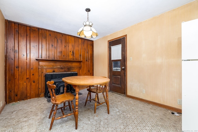 dining room with wooden walls