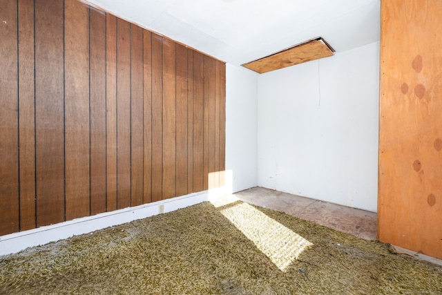 spare room featuring wooden walls