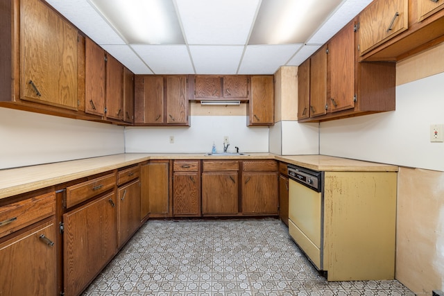 kitchen with dishwashing machine, a drop ceiling, and sink