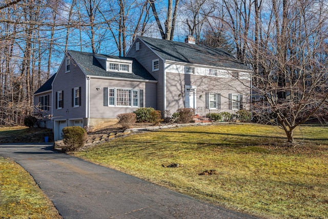 view of front of house featuring a garage and a front lawn