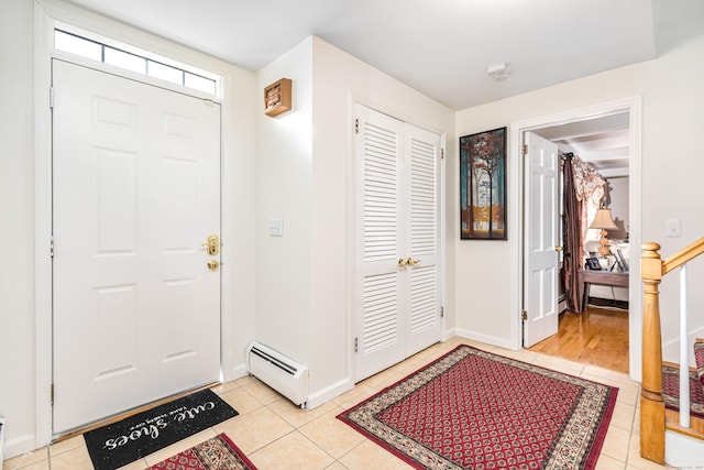 entrance foyer featuring light tile patterned floors and a baseboard heating unit