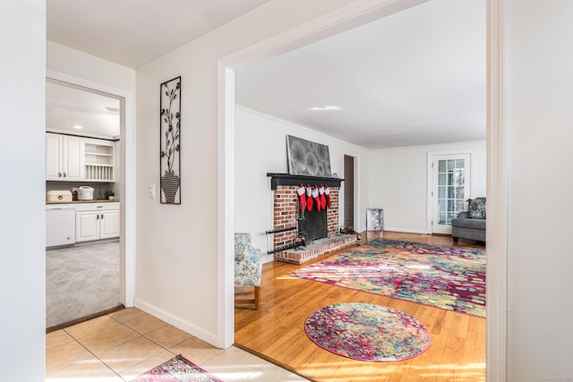 tiled living room featuring a brick fireplace