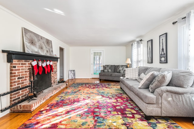 living room with a fireplace, hardwood / wood-style flooring, and ornamental molding