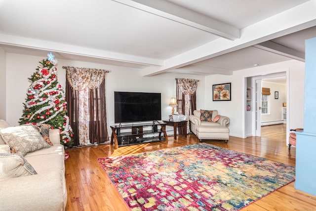 living room with beamed ceiling, a baseboard radiator, and wood-type flooring