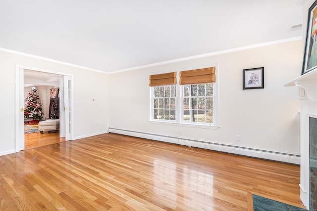 unfurnished living room featuring ornamental molding, light hardwood / wood-style flooring, and a baseboard heating unit