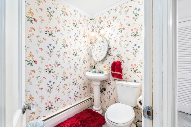 bathroom featuring toilet, baseboard heating, and crown molding