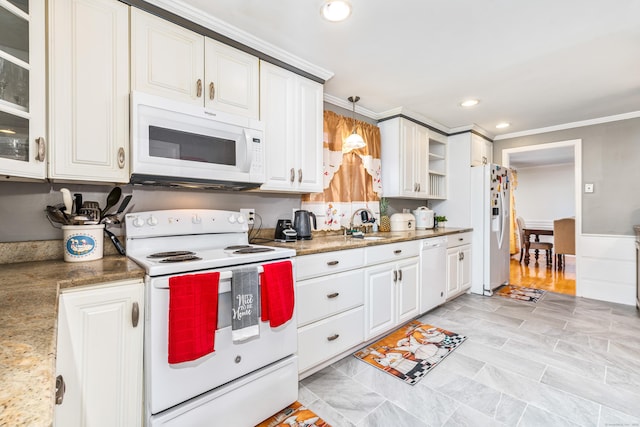 kitchen with light stone countertops, white cabinetry, pendant lighting, white appliances, and ornamental molding