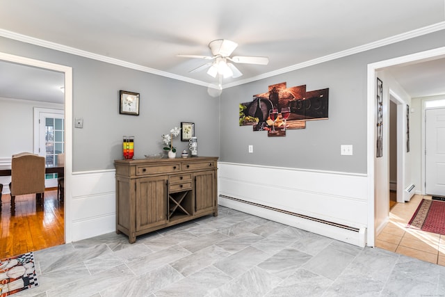 interior space with ceiling fan, ornamental molding, and a baseboard heating unit