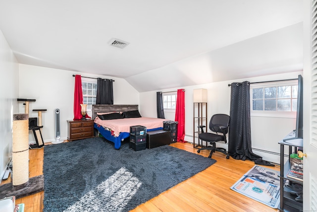 bedroom with hardwood / wood-style floors and lofted ceiling