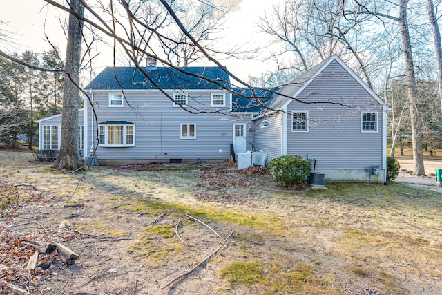 rear view of house featuring central air condition unit