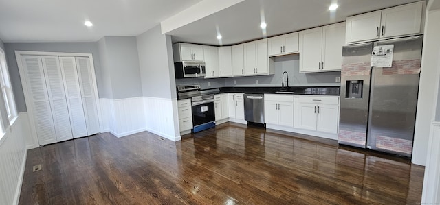 kitchen featuring sink, stainless steel appliances, and white cabinetry