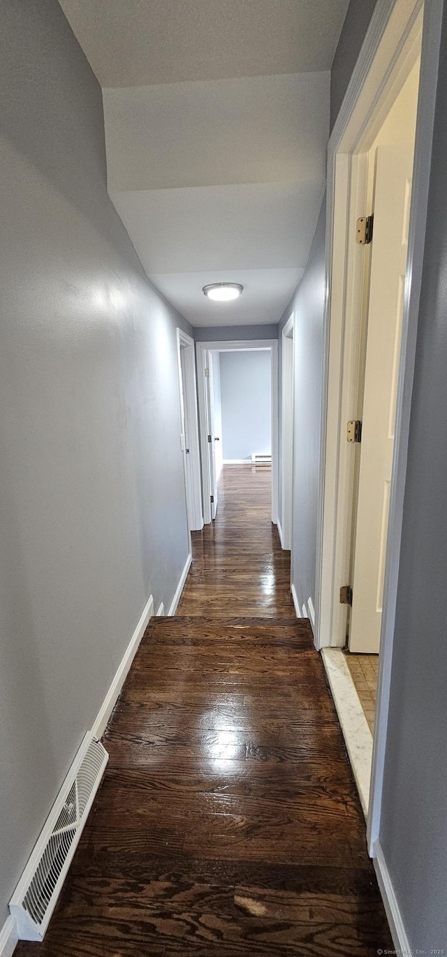 hallway featuring dark hardwood / wood-style flooring