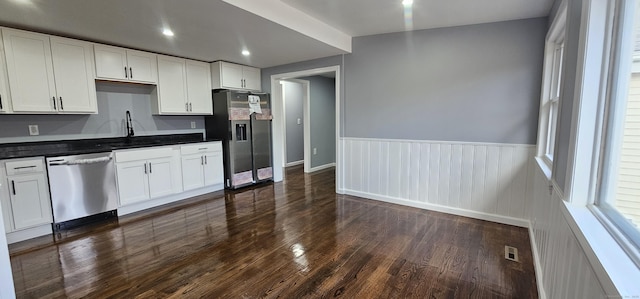 kitchen with dark wood-type flooring, sink, white cabinetry, and stainless steel appliances