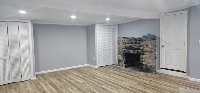 unfurnished living room featuring a fireplace and light hardwood / wood-style flooring