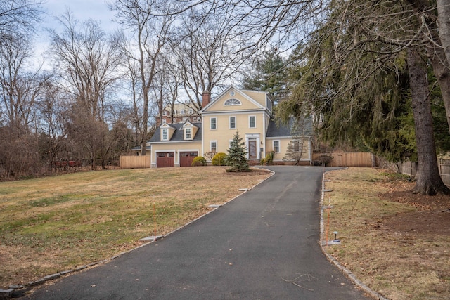 view of front of property featuring a front yard and a garage