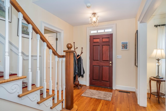 entrance foyer featuring light hardwood / wood-style flooring and an inviting chandelier