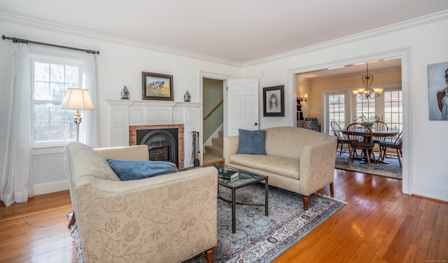 living room featuring a fireplace, a healthy amount of sunlight, and ornamental molding