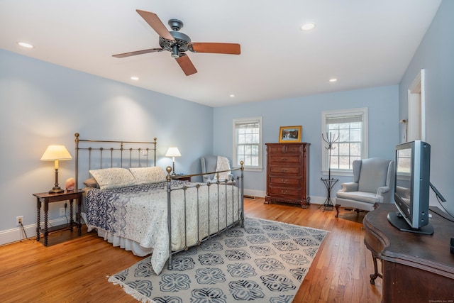 bedroom with light hardwood / wood-style floors and ceiling fan