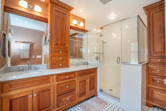 bathroom with vanity and a shower with door