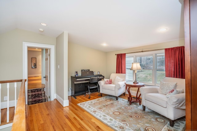 living room with hardwood / wood-style flooring and vaulted ceiling