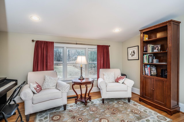 living area featuring hardwood / wood-style flooring and lofted ceiling