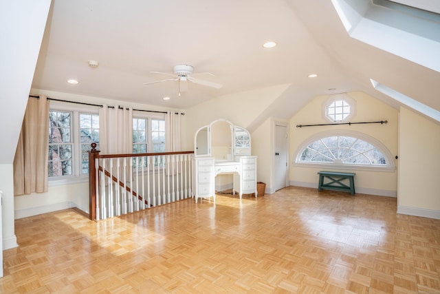 unfurnished living room featuring vaulted ceiling, light parquet floors, and ceiling fan