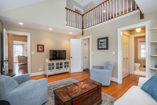 living room featuring hardwood / wood-style floors and a high ceiling