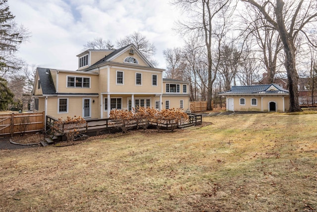 rear view of house with a yard and a deck