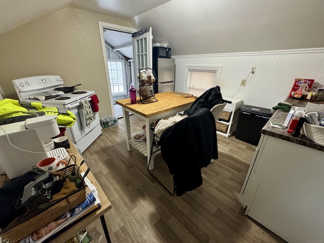 interior space featuring stainless steel refrigerator, white electric range oven, vaulted ceiling, and wood-type flooring