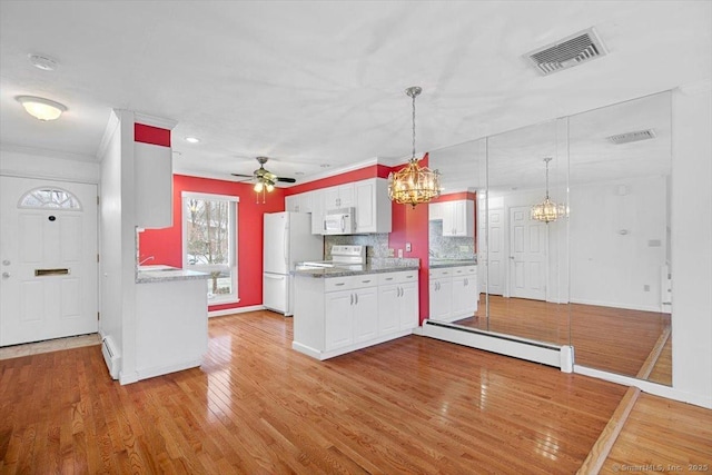 kitchen with tasteful backsplash, white appliances, a baseboard radiator, light hardwood / wood-style flooring, and white cabinetry