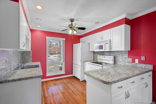 kitchen featuring white cabinets, backsplash, white appliances, and sink