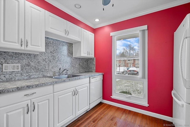 kitchen with white cabinetry, sink, light hardwood / wood-style floors, white appliances, and ornamental molding