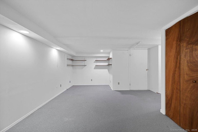 basement featuring light colored carpet