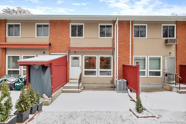 rear view of property with central AC unit