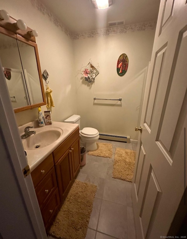 bathroom featuring tile patterned flooring, vanity, toilet, and a baseboard heating unit