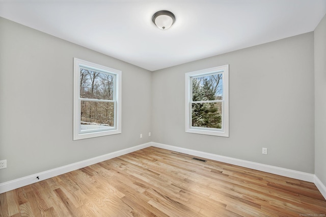 spare room with light hardwood / wood-style flooring