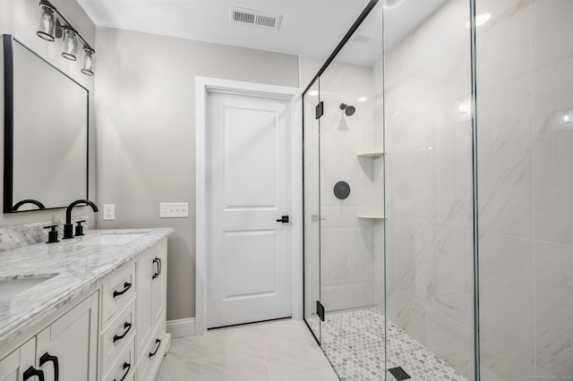 bathroom with a shower with shower door and vanity