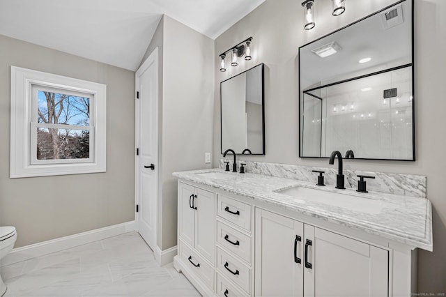 bathroom featuring walk in shower, vanity, and toilet