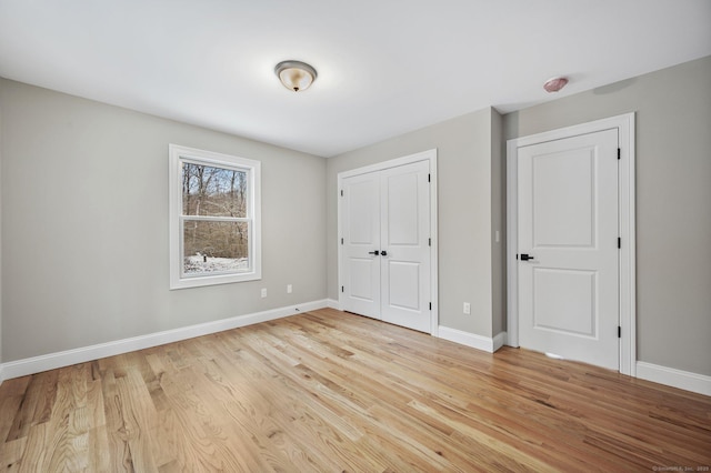 unfurnished bedroom with light wood-type flooring