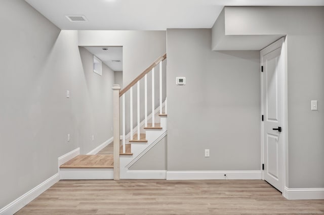 staircase with hardwood / wood-style floors