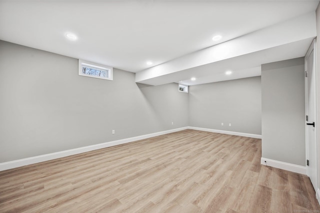 basement with light hardwood / wood-style floors