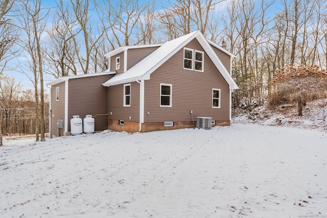 view of snow covered exterior with central AC