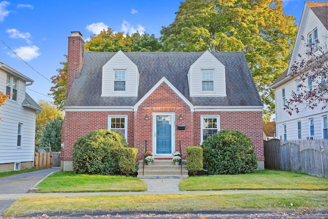 new england style home with a front yard