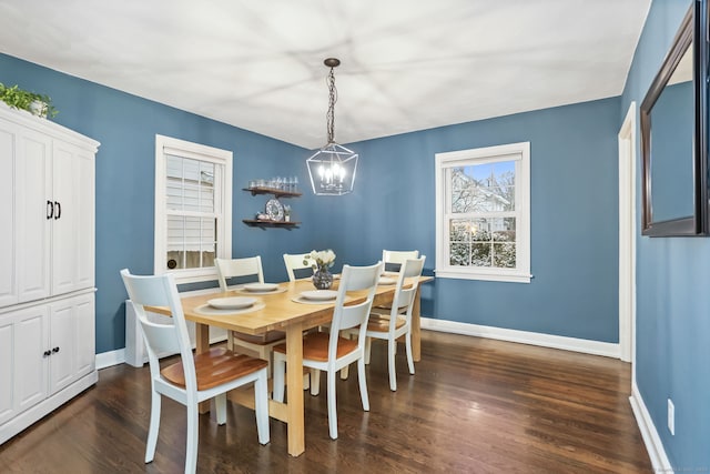 dining room featuring dark hardwood / wood-style flooring and a notable chandelier